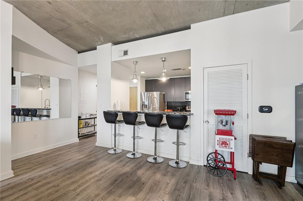 250 Pharr Road Northeast, Unit 1005 Atlanta, GA 30305 - Photo 3 of 25 a view of a livingroom with furniture and wooden floor