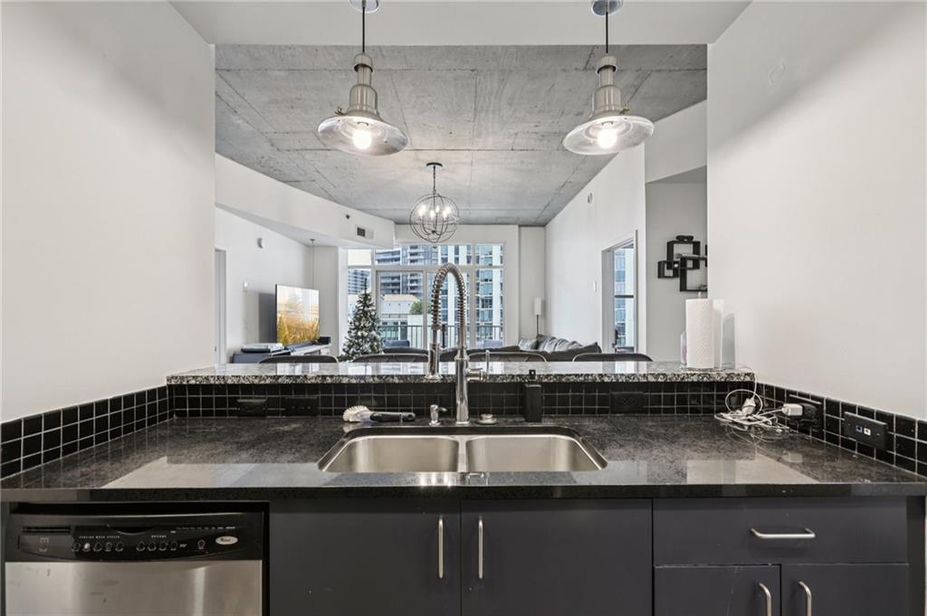 250 Pharr Road Northeast, Unit 1005 Atlanta, GA 30305 - Photo 6 of 25 a kitchen with a sink and chandelier
