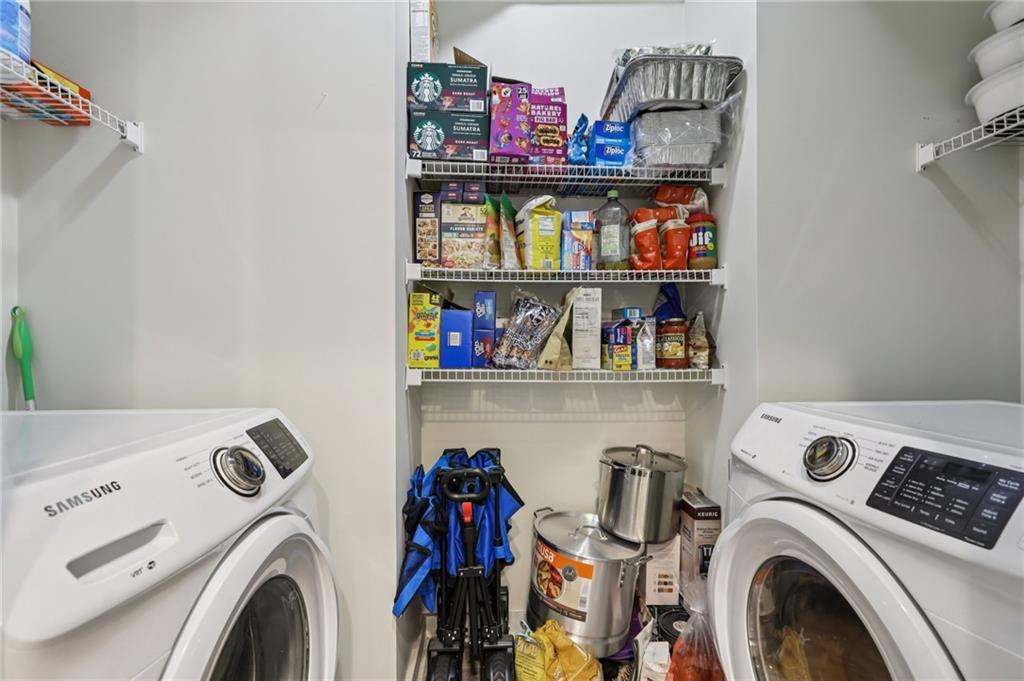 250 Pharr Road Northeast, Unit 1005 Atlanta, GA 30305 - Photo 7 of 25 a view of storage and utility room with washer and dryer