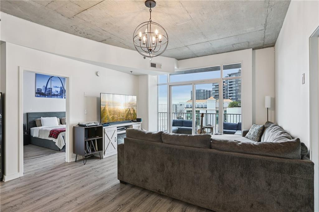 250 Pharr Road Northeast, Unit 1005 Atlanta, GA 30305 - Photo 8 of 25 a living room with furniture and a flat screen tv