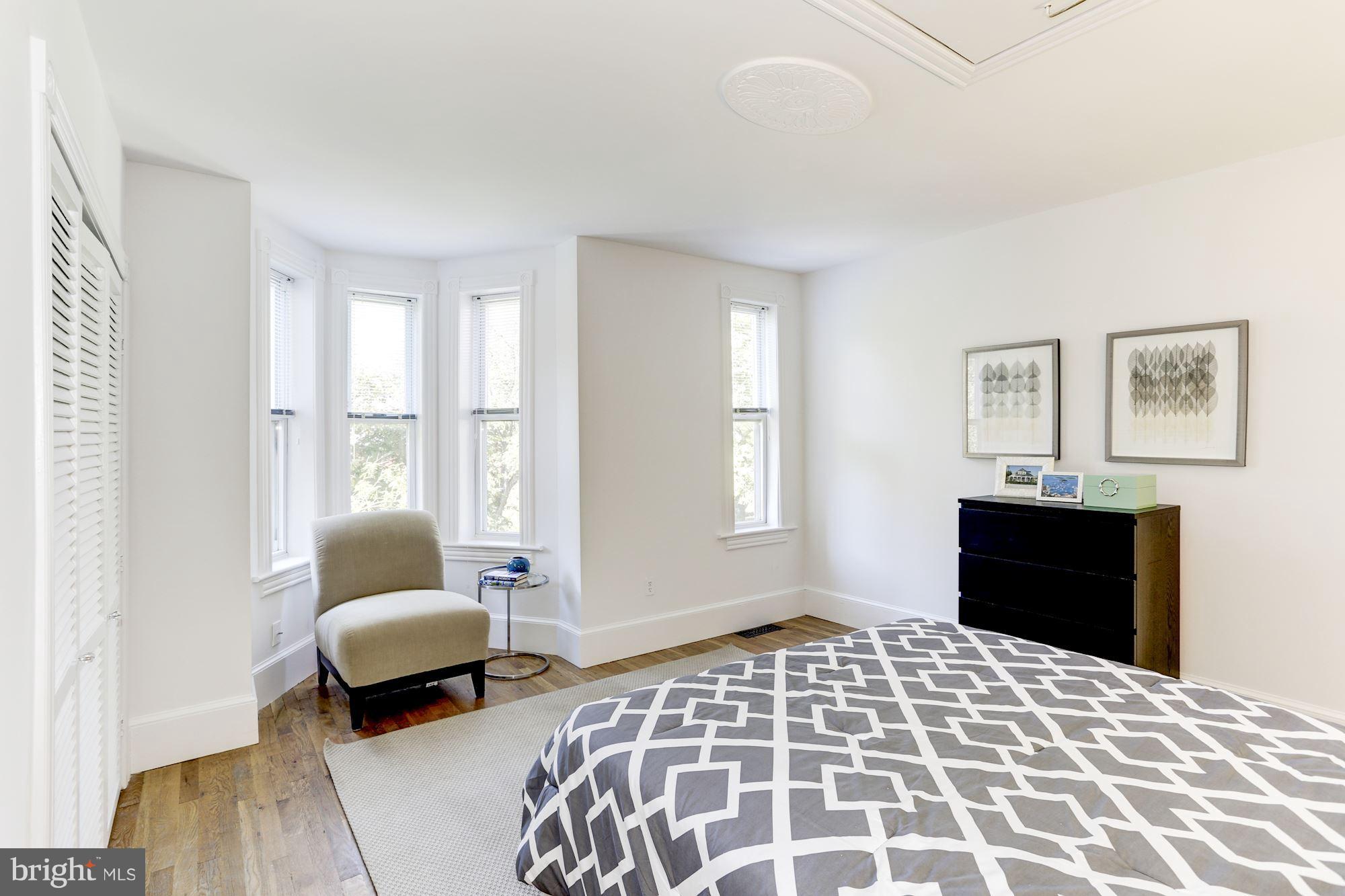 425 5th Street Northeast Washington, DC 20002 - Photo 13 of 21 a bedroom with a bed and wooden floor