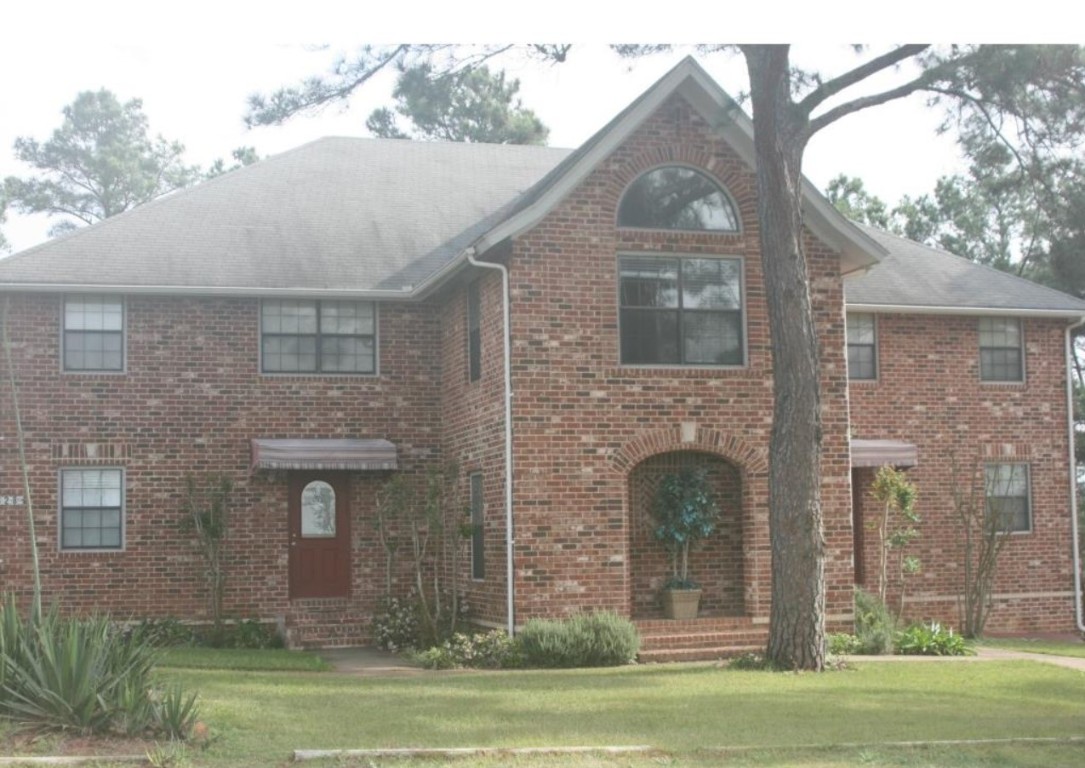 828 State Highway 71 Bastrop, TX 78602 - Photo 2 of 4 a front view of a house with a garden