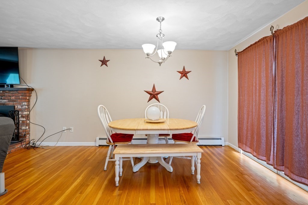 179 Beaman Road Princeton, MA 01541 - Photo 11 of 34 a view of a dining room with furniture wooden floor and chandelier