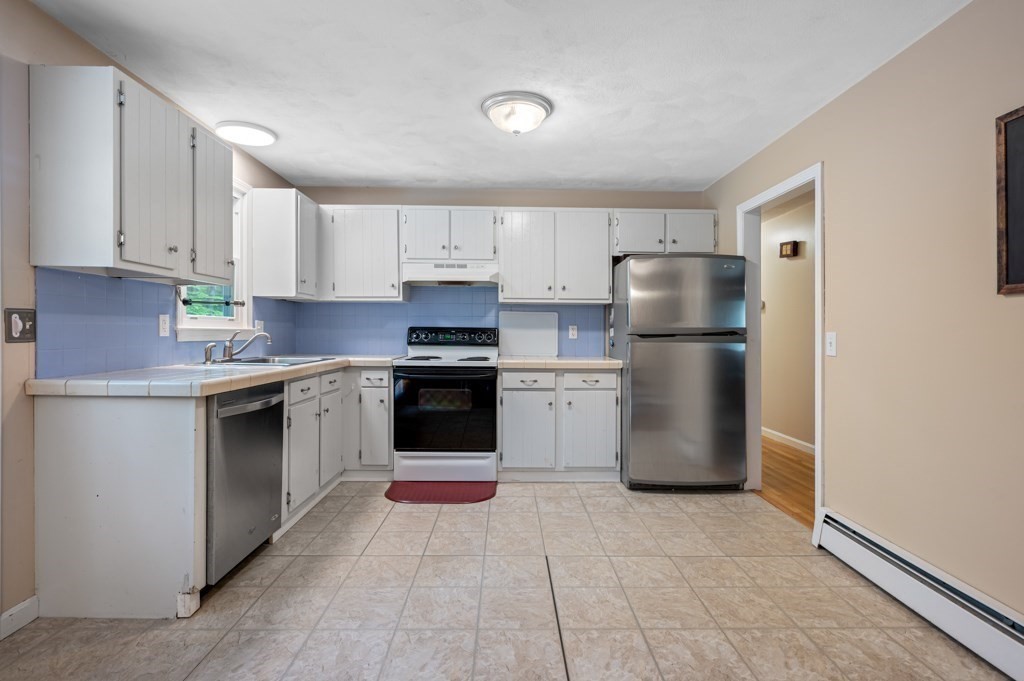 179 Beaman Road Princeton, MA 01541 - Photo 12 of 34 a kitchen with a refrigerator sink and cabinets