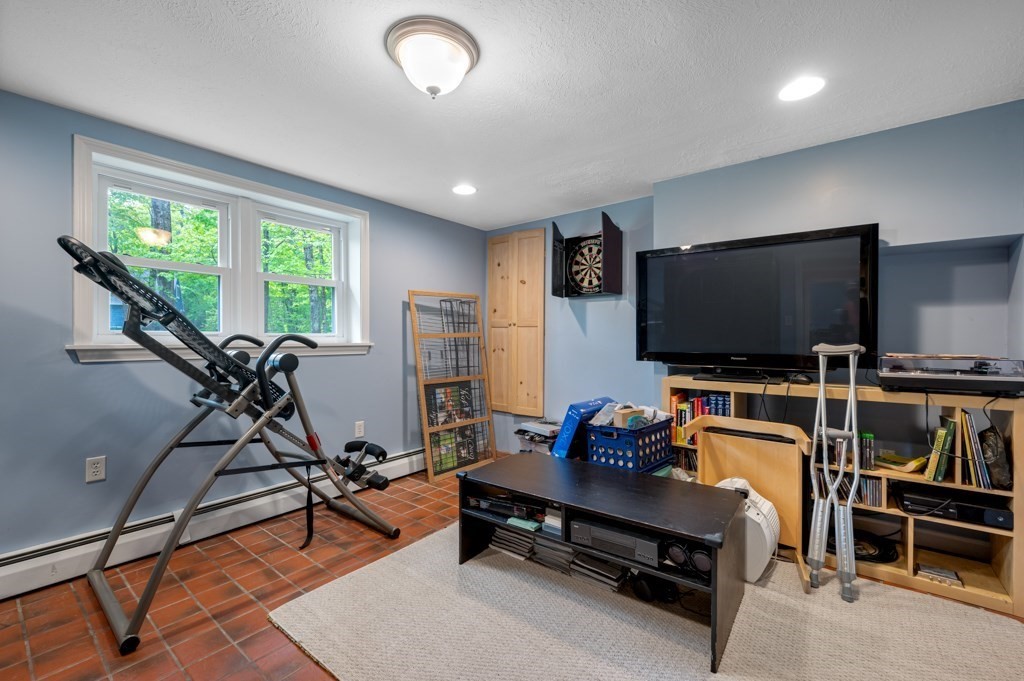 179 Beaman Road Princeton, MA 01541 - Photo 24 of 34 a living room with furniture and a flat screen tv