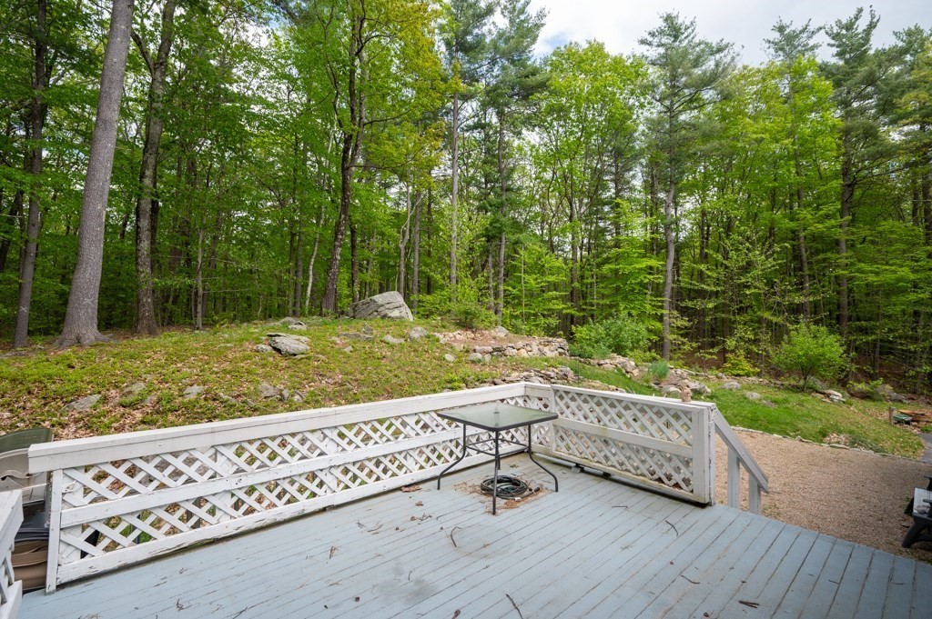 179 Beaman Road Princeton, MA 01541 - Photo 31 of 34 a view of a wooden bench and trees in the background