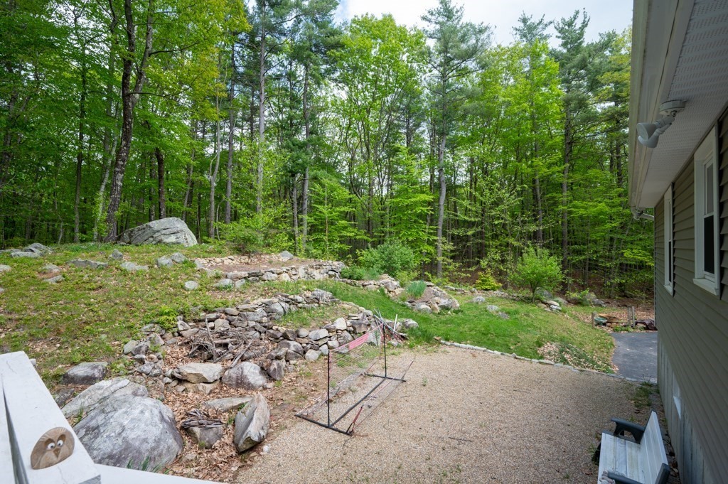 179 Beaman Road Princeton, MA 01541 - Photo 32 of 34 a backyard of a house with lots of green space
