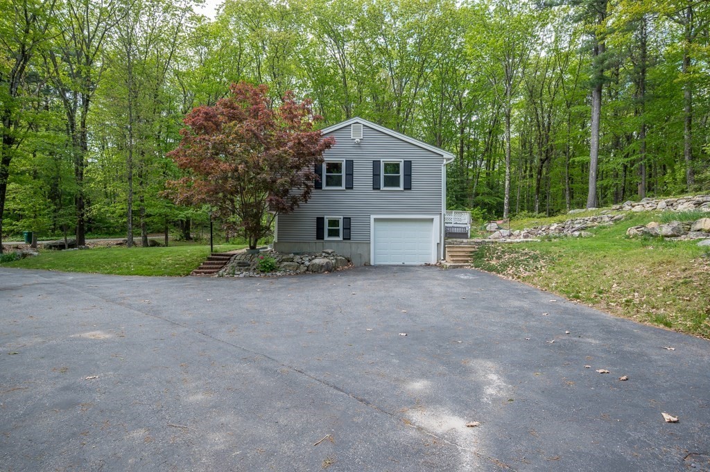 179 Beaman Road Princeton, MA 01541 - Photo 34 of 34 a front view of a house with a yard and garage
