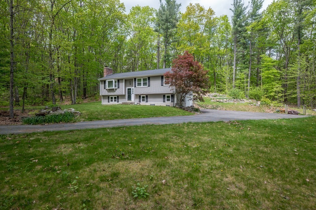 179 Beaman Road Princeton, MA 01541 - Photo 4 of 34 a view of a house next to a big yard and large trees