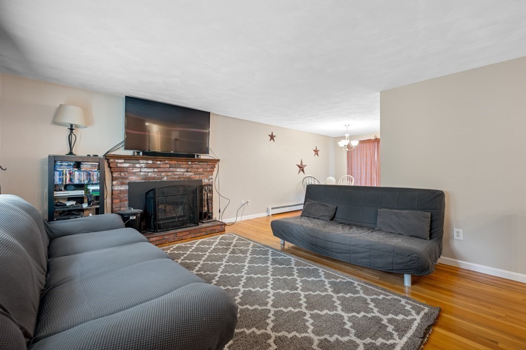 179 Beaman Road Princeton, MA 01541 - Photo 8 of 34 a living room with furniture a flat screen tv and a fireplace