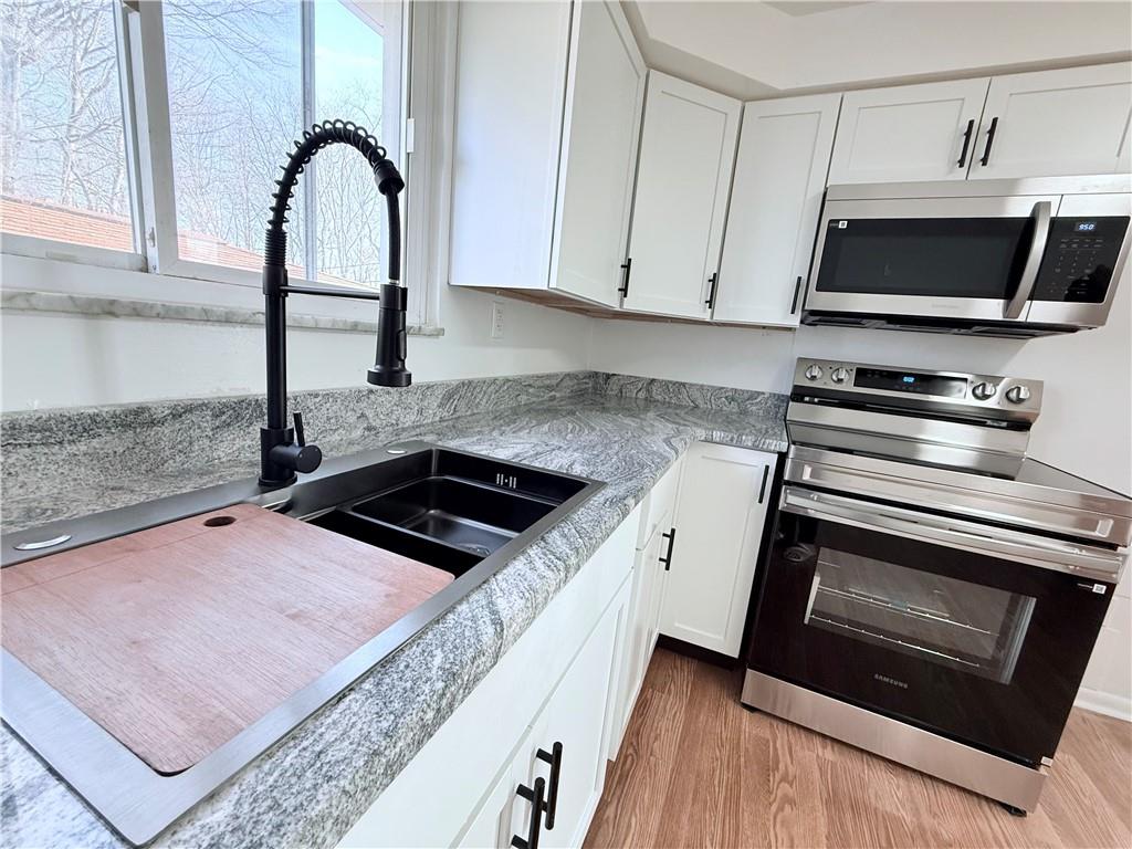 2724 Lookout Drive Elizabeth, PA 15037 - Photo 12 of 31 a kitchen with a stove and a microwave