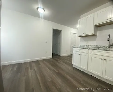 a view of cabinets a sink and wooden floor