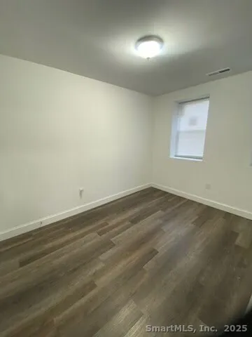 en empty room with wooden floor