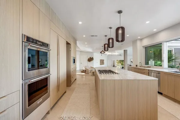 a kitchen with a sink a stove and refrigerator