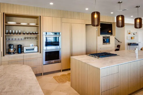 a kitchen with stainless steel appliances a stove a microwave and white cabinets
