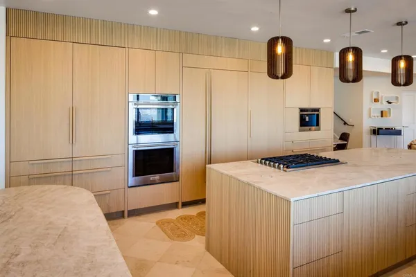 a living room with furniture and kitchen view