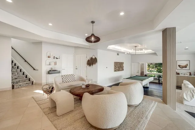 a view of living room with furniture and a chandelier