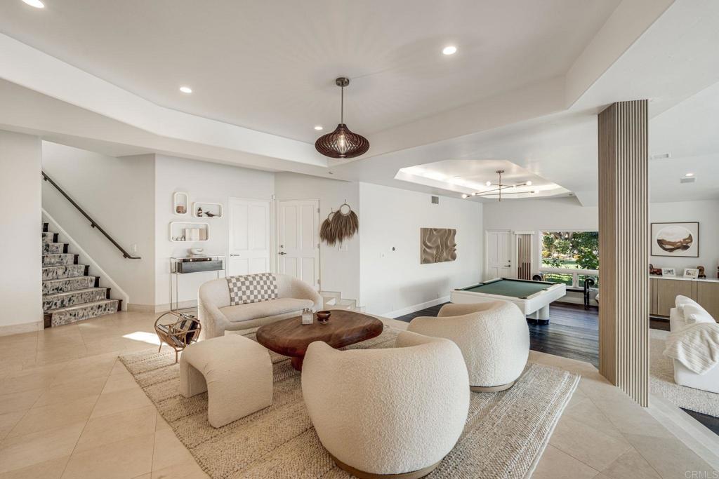 1904 Via Casa Alta La Jolla, CA 92037 - Photo 16 of 60 a living room with furniture kitchen view and a chandelier