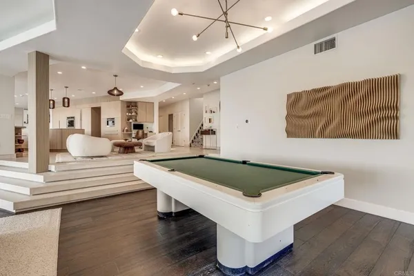 a view of living room with furniture and wooden floor
