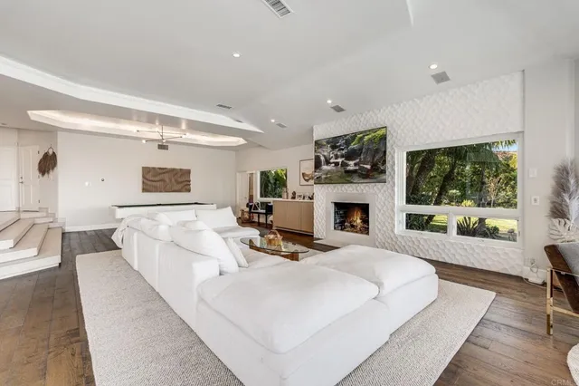 a living room with furniture and a floor to ceiling window