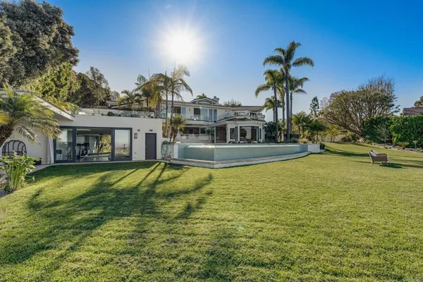 a view of a backyard with a garden and patio