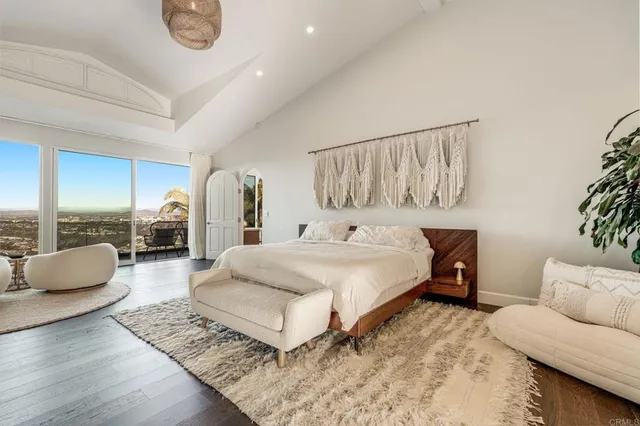 a bedroom with furniture and a large mirror