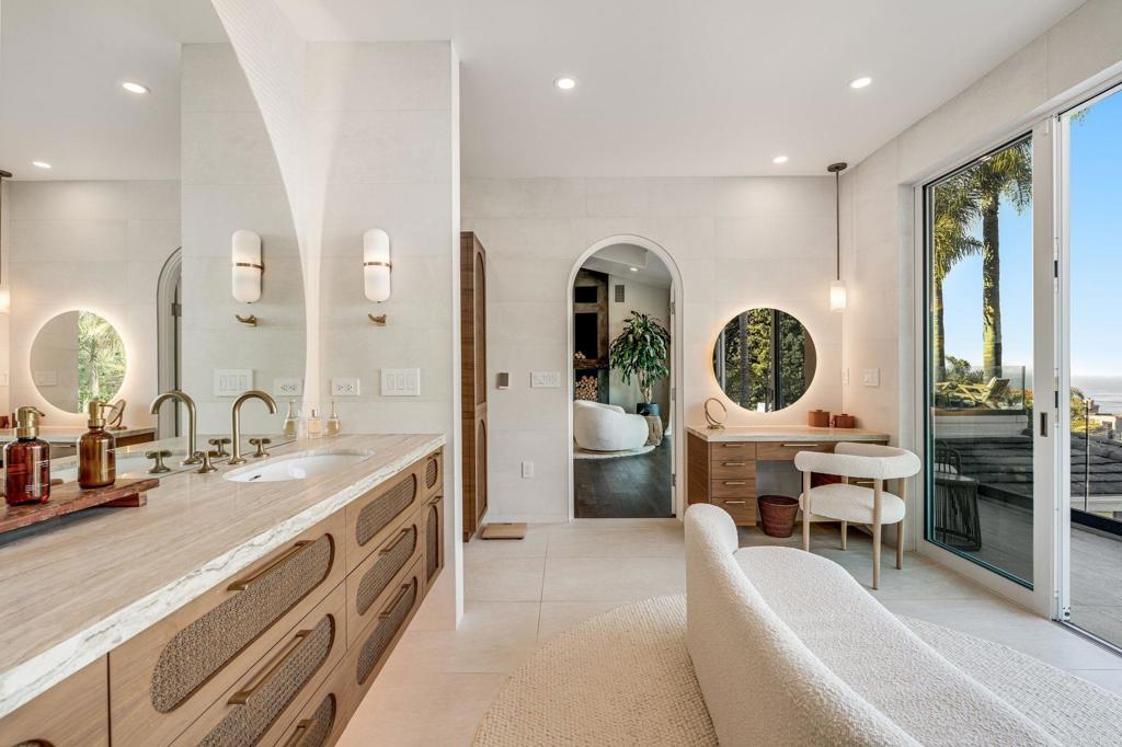 1904 Via Casa Alta La Jolla, CA 92037 - Photo 51 of 60 a large bathroom with a double vanity sink a mirror and a shower
