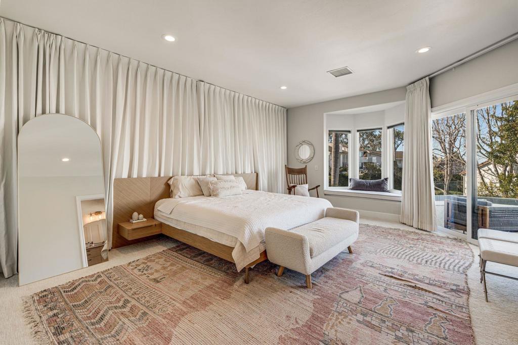1904 Via Casa Alta La Jolla, CA 92037 - Photo 54 of 60 a spacious bedroom with a large bed and a large window