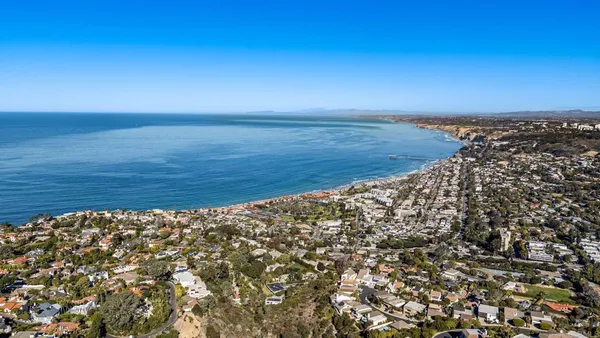 a large kitchen with kitchen island a island a sink a stove and a refrigerator