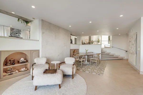 a large kitchen with stainless steel appliances a sink and cabinets