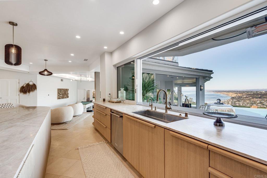 1904 Via Casa Alta La Jolla, CA 92037 - Photo 10 of 60 a large kitchen with stainless steel appliances a sink and cabinets