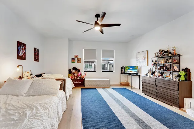 a bedroom with furniture and a wooden floor