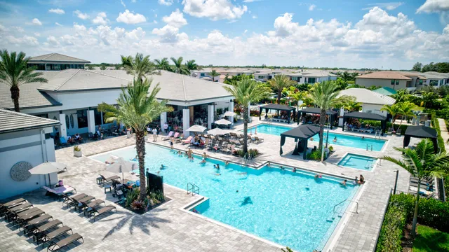 a front view of a house with garden and chairs