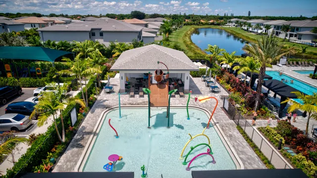 an aerial view of a house with swimming pool and outdoor seating
