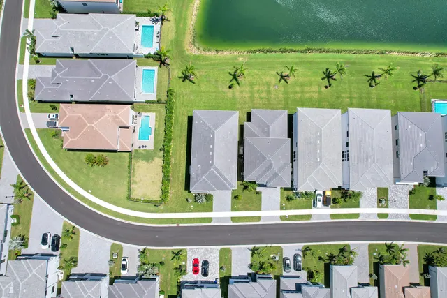 an aerial view of a house with a garden and swimming pool