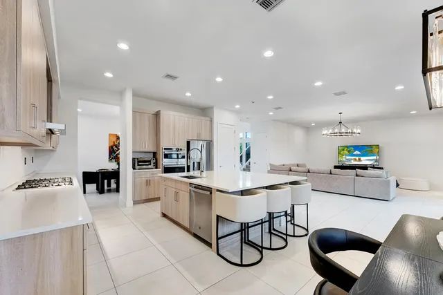 a kitchen with a sink and chairs