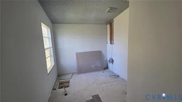 a view of an empty room and a window