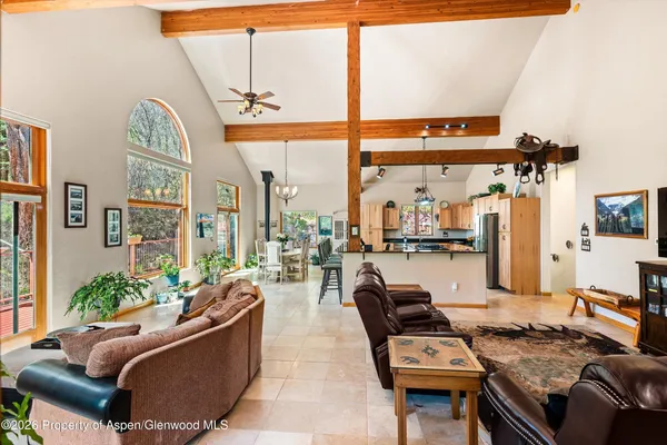 a living room with furniture and a floor to ceiling window