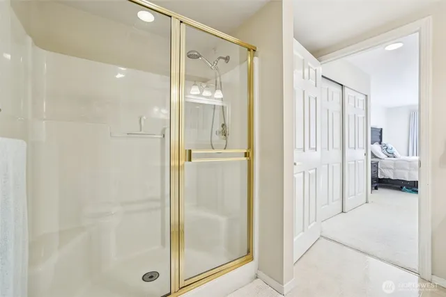 a bathroom with a glass shower door and a sink