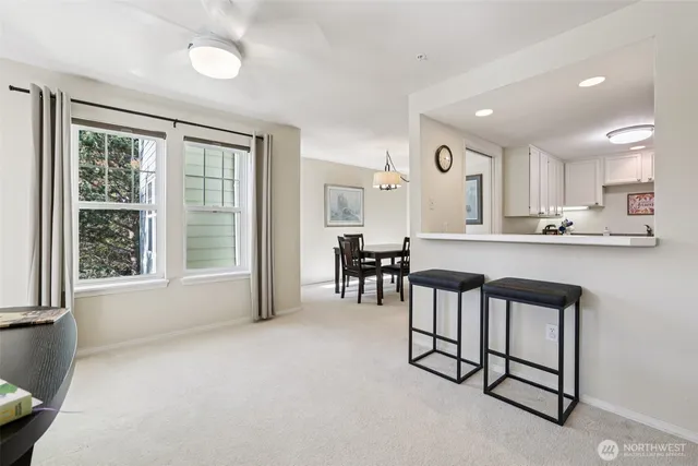 a kitchen with stainless steel appliances granite countertop a stove a sink a refrigerator and white cabinets with wooden floor