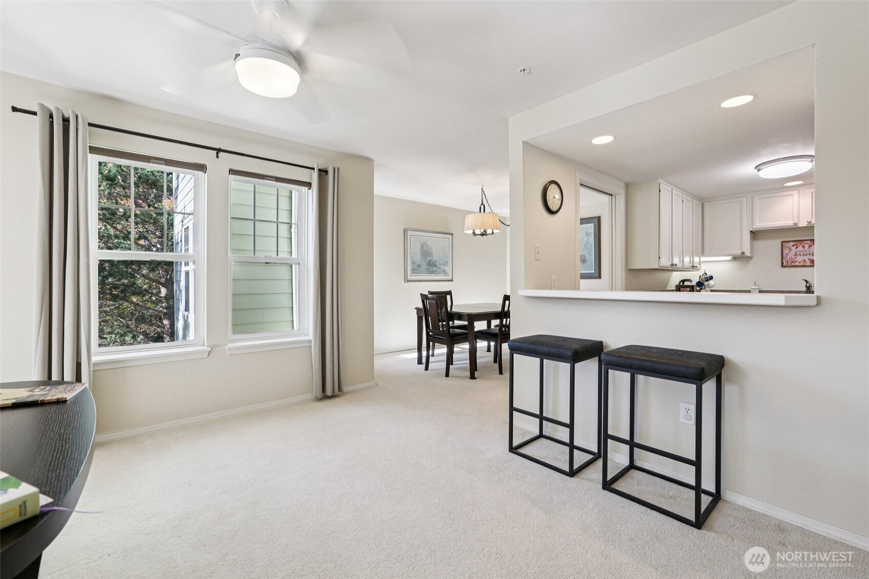 4109 224th Lane Southeast, Unit 207 Issaquah, WA 98029 - Photo 20 of 32 a kitchen with stainless steel appliances granite countertop a stove a sink a refrigerator and white cabinets with wooden floor