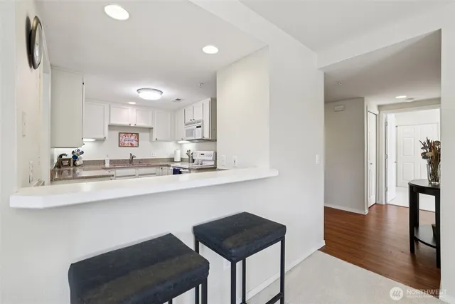 a kitchen with a sink cabinets and wooden floor