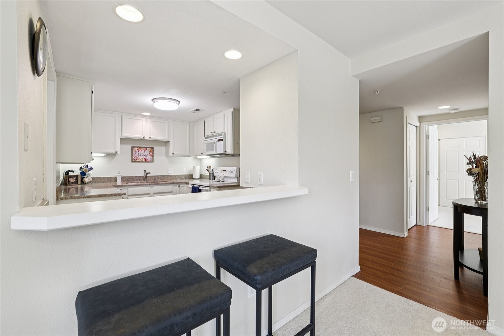 4109 224th Lane Southeast, Unit 207 Issaquah, WA 98029 - Photo 21 of 32 a kitchen with a sink cabinets and wooden floor