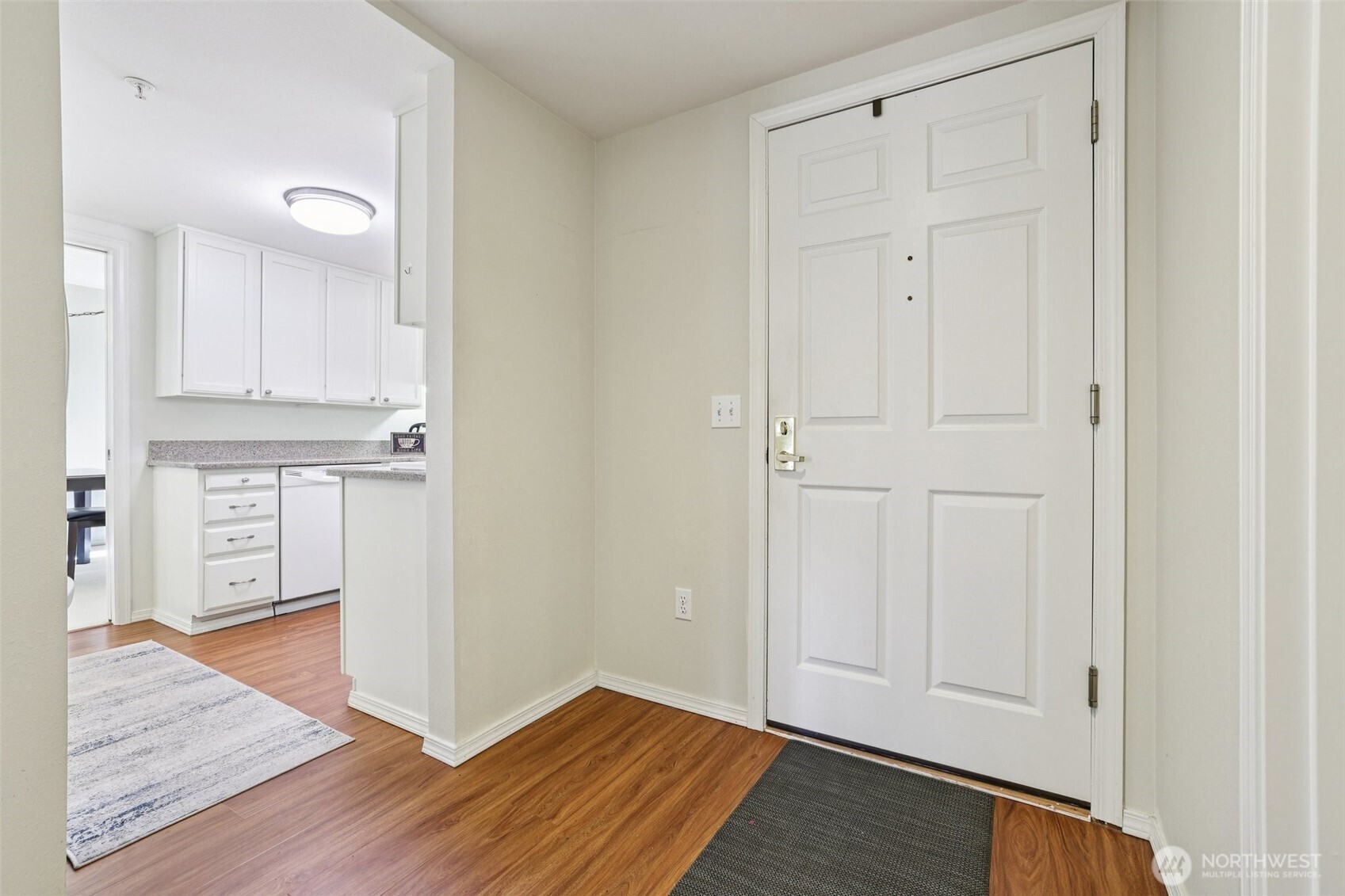 4109 224th Lane Southeast, Unit 207 Issaquah, WA 98029 - Photo 24 of 32 a view of a kitchen with wooden floor and a sink