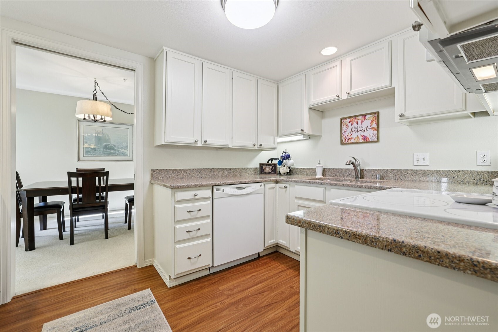 4109 224th Lane Southeast, Unit 207 Issaquah, WA 98029 - Photo 10 of 32 a kitchen with granite countertop a sink cabinets and wooden floor