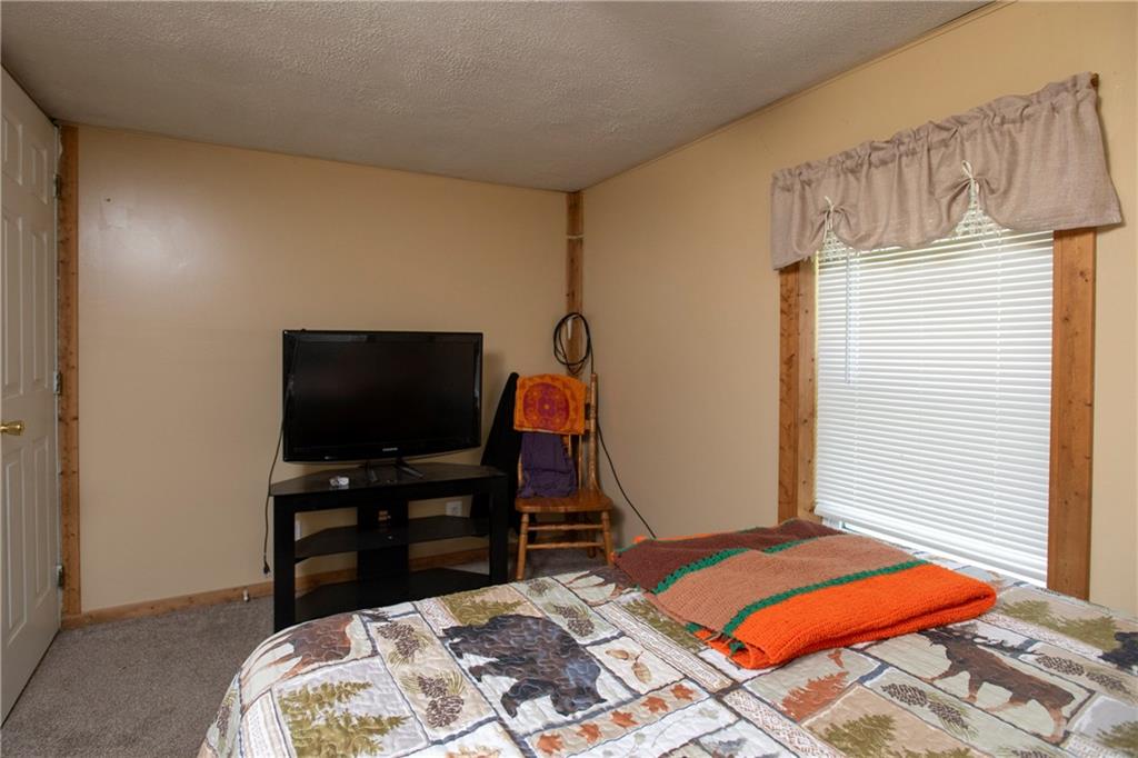 9133 South Watson Run Road Meadville, PA 16335 - Photo 27 of 45 a bedroom with a bed and a flat screen tv