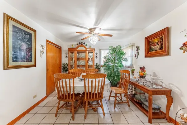 a view of a dining room with furniture and a chandelier fan