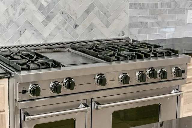 a stove top oven sitting inside of a kitchen