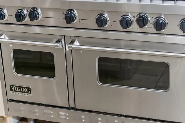 a view of a kitchen with a sink and a fireplace