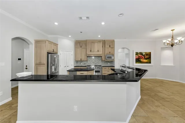 a close view of a stove a microwave and cabinets